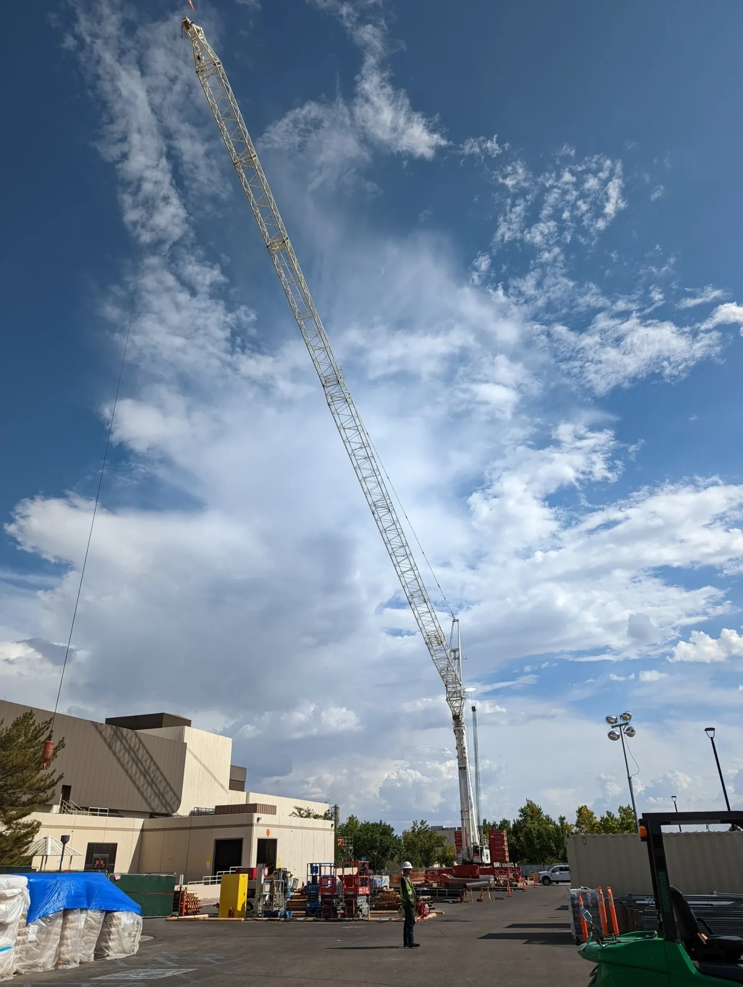 A crane is in the sky over some buildings.