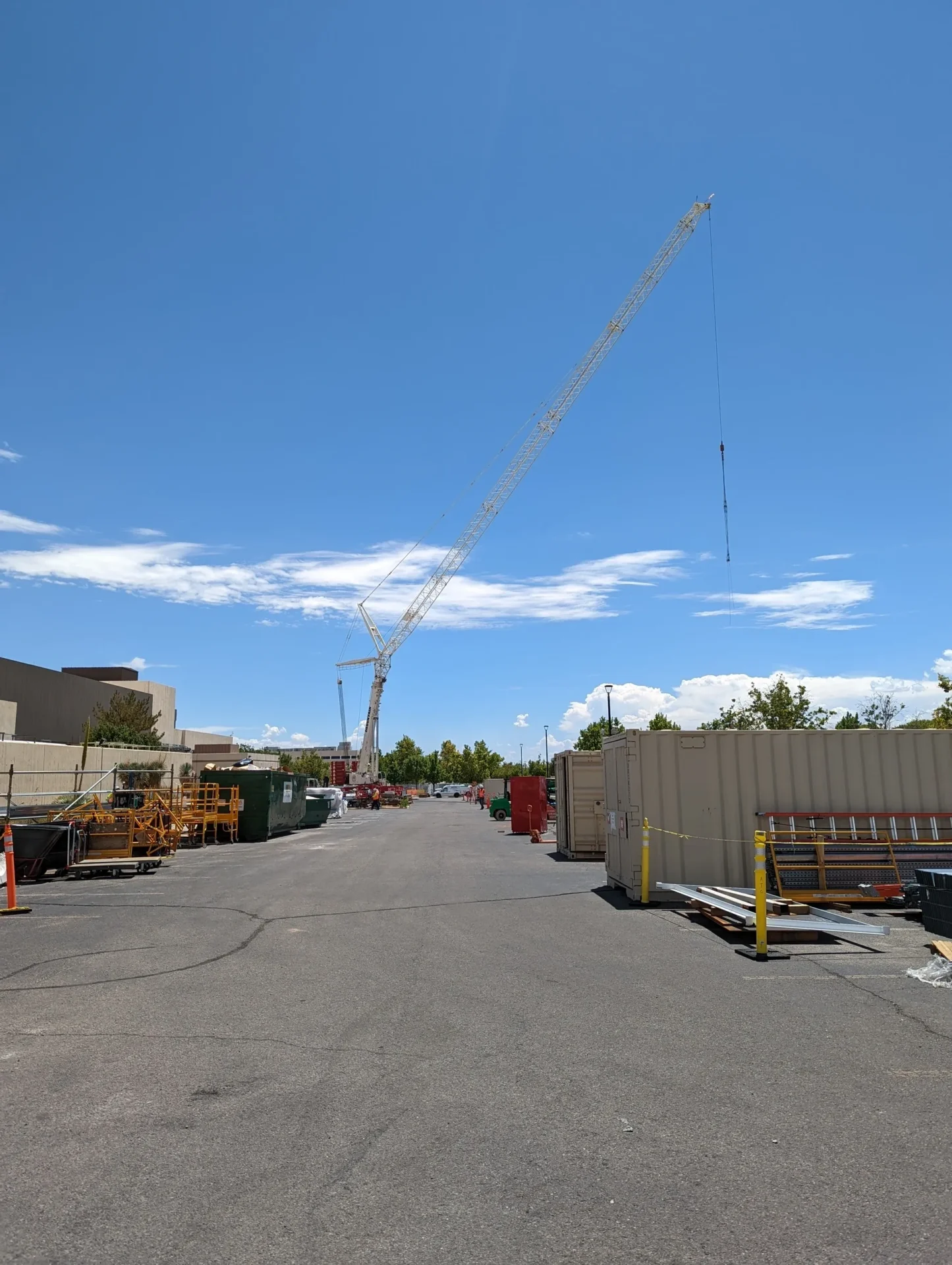 A crane is in the middle of an empty lot.