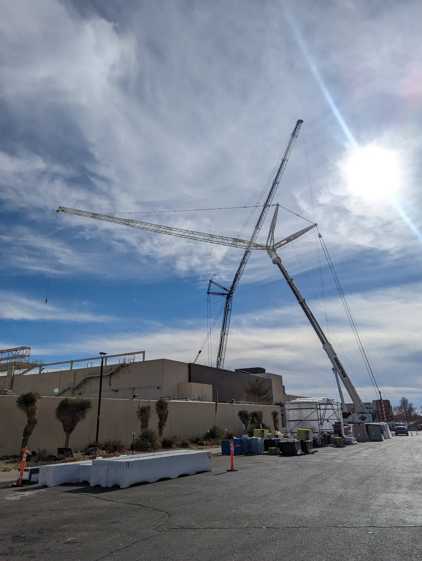 A crane is in the sky over a building.