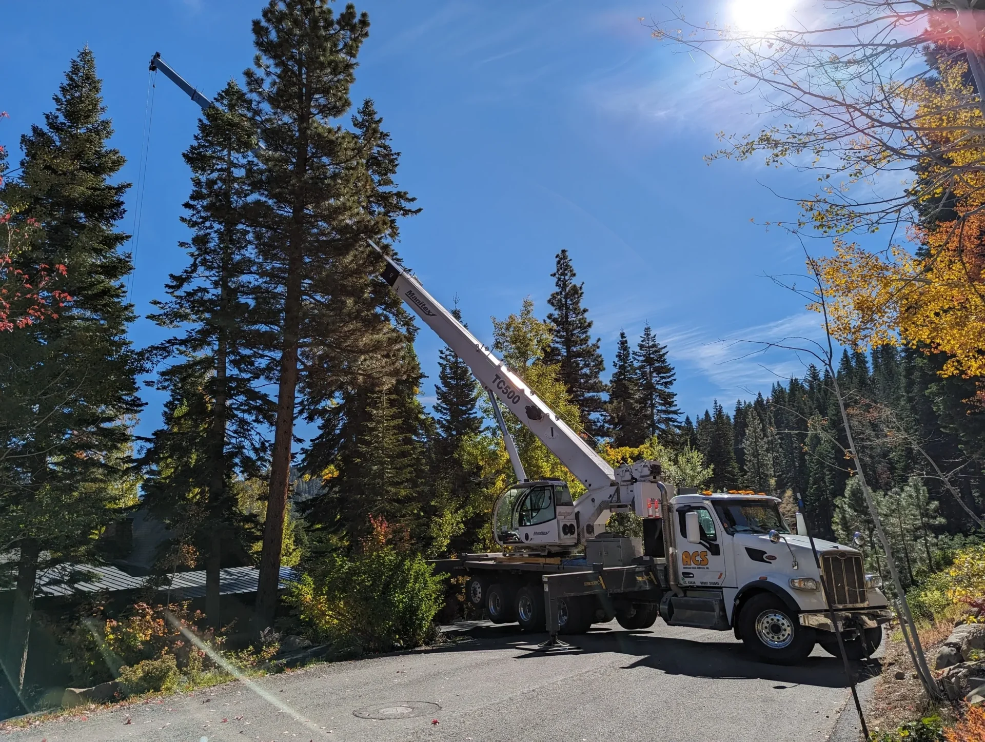 A crane is in the back of a truck.