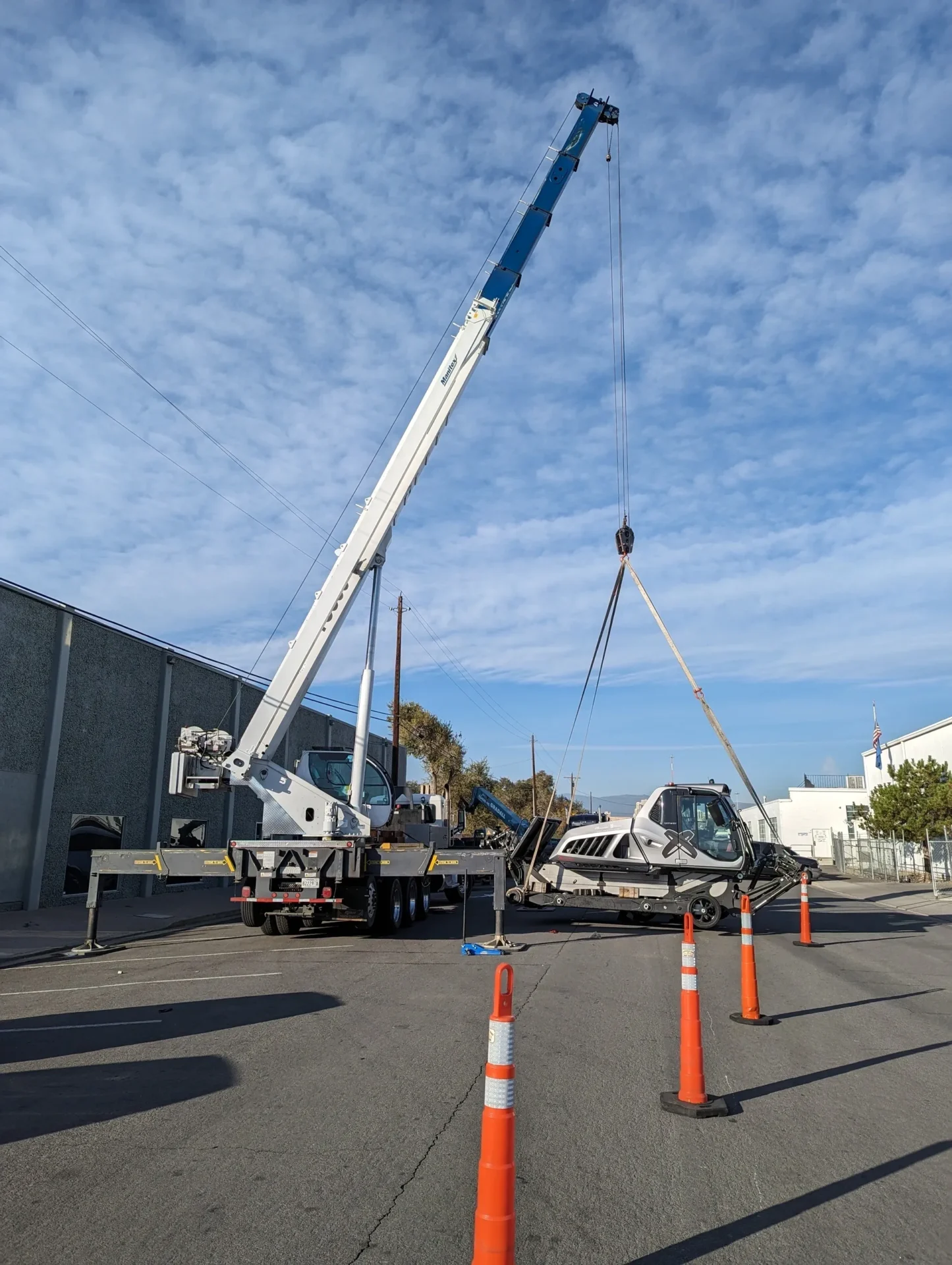 A crane is being used to lift a car.