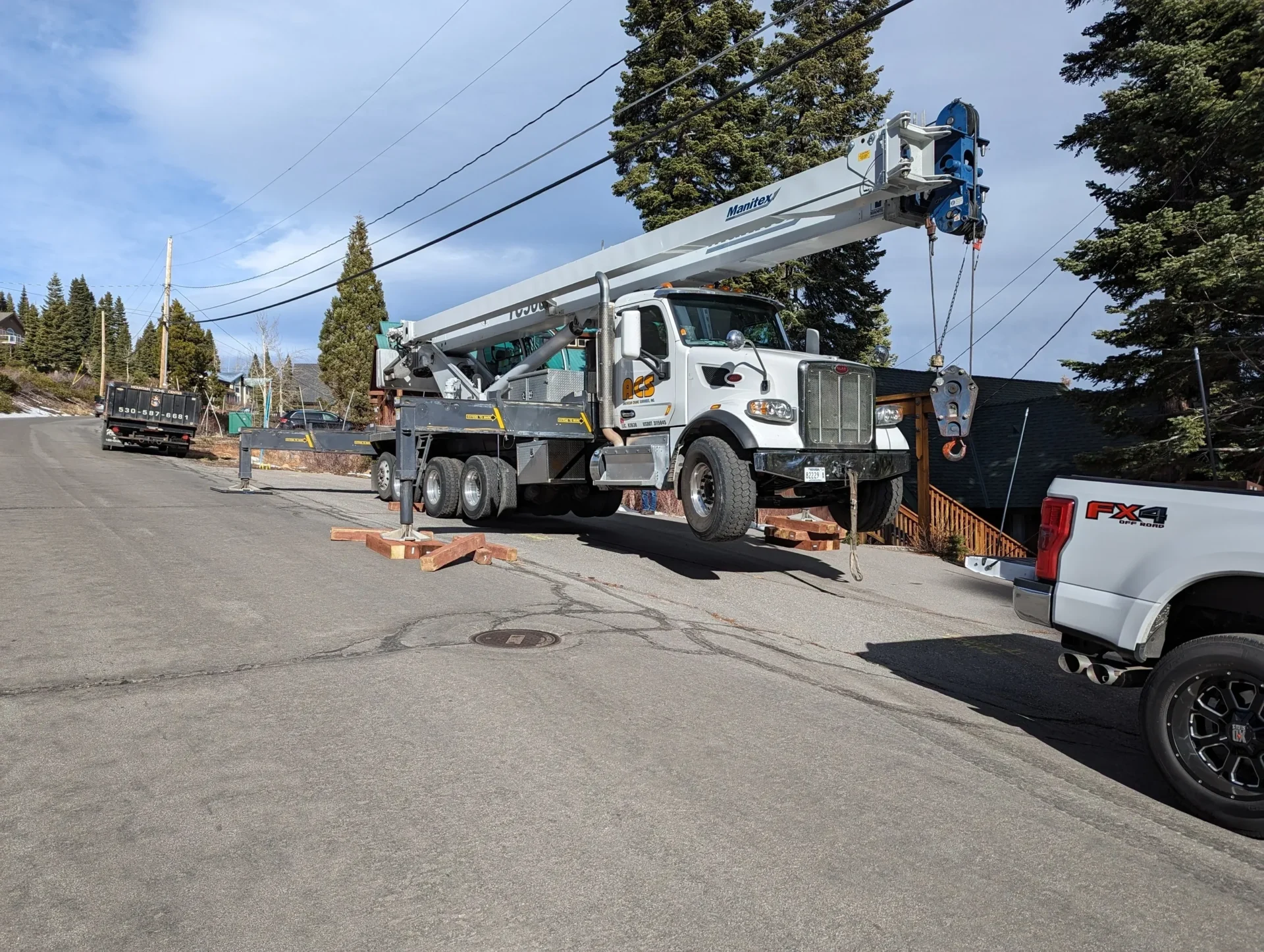 A crane is parked on the side of the road.