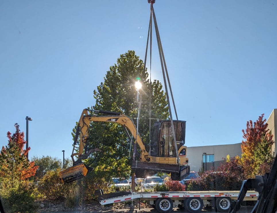 A crane is lifting a large piece of machinery.