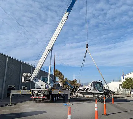 A crane is being used to lift a plane.